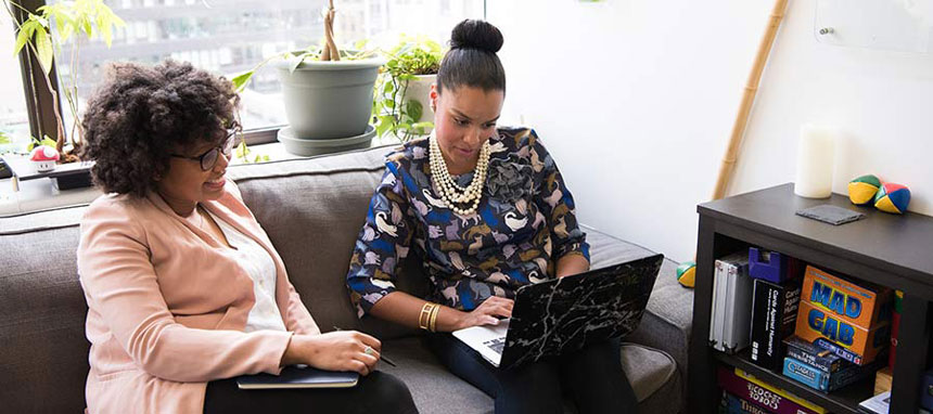 Two people looking at a computer screen.